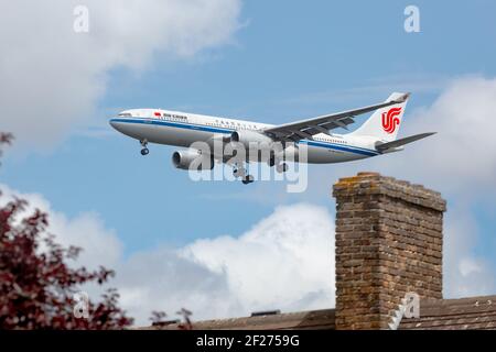 London, UK, June 2020. An Air China, Airbus A330 aircraft on final approach to Heathrow as it flys over residential homes. image Abdul Quraishi Stock Photo