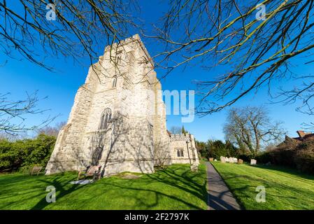 Church of St. Nicholas parish church in Canewdon, Essex, UK. Ragstone rubble historic church. 14th-century Parish Church in blue sky Stock Photo