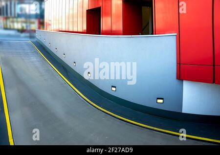 Entrance to an underground car park with modern red and grey wall cladding Stock Photo