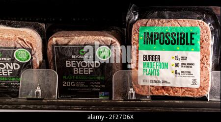 Germantown, MD, USA 01-15-2021: Two popular vegan meat alternative brands Impossible and Beyond beef are sold side by side on a grocery shelf. These a Stock Photo