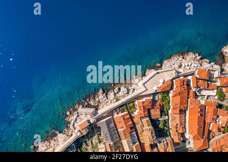 Aerial overhead drone shot of Dubrovnik old town city wall by Adriatic sea in Croatia summer Stock Photo
