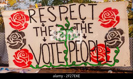 Washington DC, USA 11-08-2020: A political banner hanging on chain fence near White House after election says: " Respect the Vote, Respect The People Stock Photo