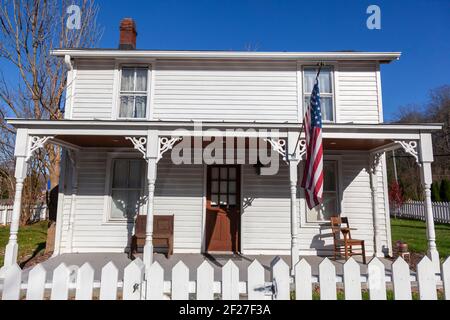 Clifton, VA, USA 11-14-2020: A two story, white, wooden, well preserved, vintage, 19th century single family home located in historic Clifton, a small Stock Photo