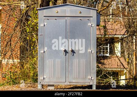 Stainless steel metal cabinet for outdoor use. Immobilized to ground and locked with padlocks this brushed steel heavy duty cabinet is good for storin Stock Photo