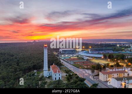 Aerial drone view of Vila Real de Santo Antonio city, lighthouse farol and stadium in Portugal, at sunset Stock Photo