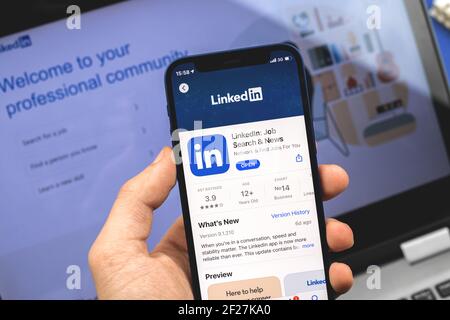 Kharkov, Ukraine - March 9, 2021: LinkedIn website and application on the screen, man is search for the new job and opportunity Stock Photo