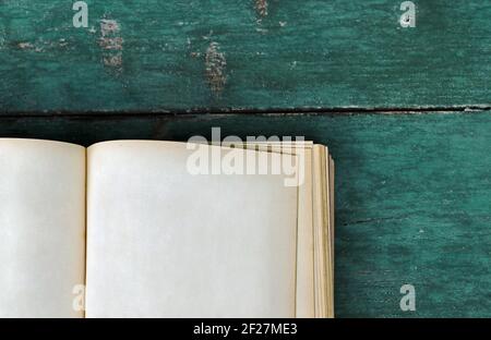 An old book with blank pages on a blue wooden background Stock Photo