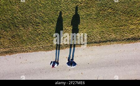 Aerial shot with drone of two people with a long shadow Stock Photo - Alamy