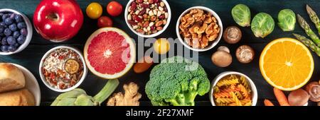 Healthy vegan food panorama. Top shot of fruits and vegetables, legumes, mushrooms, nuts. Balanced diet concept Stock Photo