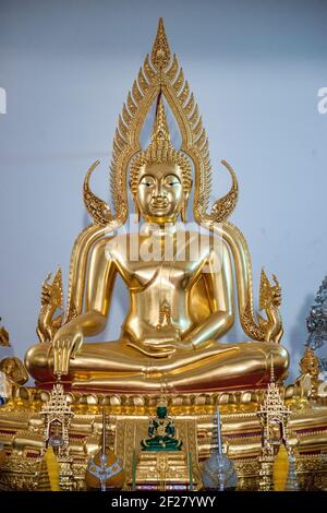 The golden seated Buddha in the center of the altar area inside the Thai Buddhist Temple, Wat Buddharangsi of Miami, located in the rural Redland area Stock Photo