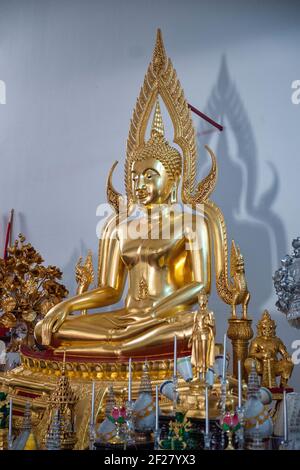 The golden seated Buddha in the center of the altar area inside the Thai Buddhist Temple, Wat Buddharangsi of Miami, located in the rural Redland area Stock Photo