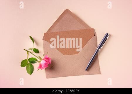 Invitation or greeting card mock up in a craft envelope, overhead flatlay shot Stock Photo