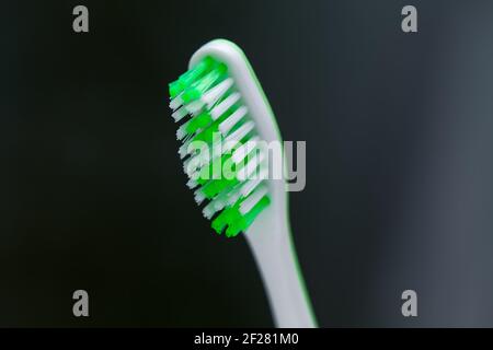 Toothbrush on a dark background . Soft toothbrush for gentle clean for sensitive teeth Stock Photo