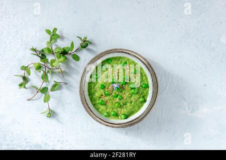 Green vegetable soup, shot from the top, with green peas Stock Photo