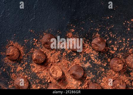 Chocolate truffles, shot from above on a black background Stock Photo
