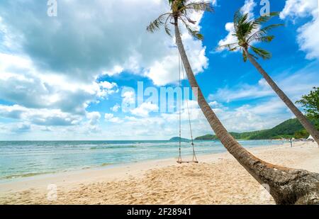 Swing attached to a palm tree in the idyllic Sao beach in Phu Quoc island, Vietnam. Sao beach is one of the best beaches of Vietnam. Stock Photo