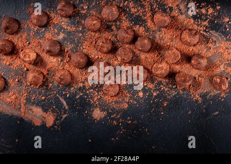 Many chocolate truffles with cocoa powder, overhead flat lay shot Stock Photo