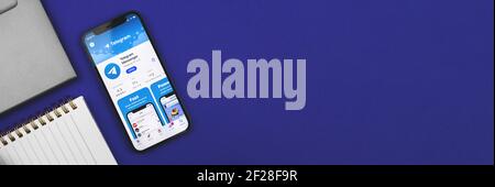 Kharkov, Ukraine - March 9, 2021: Telegram app on the Apple iPhone screen, banner with copy space, minimal workspace and new normal concept photo Stock Photo