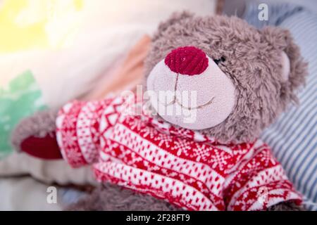 Teddy dream concept: Teddy bear is sitting in the bed Stock Photo