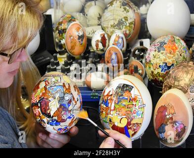 Leipzig, Germany. 08th Mar, 2021. Easter egg artist Kerstin Dischereit works a goose egg on two ostrich eggs in her "Easter Bunny Workshop," which she painted with the Corona theme "Home Chaos 2021." The illustrations depict bunnies from the nearly 100-year-old classic picture book "The Bunny School" struggling with home offices and homeschooling. Since the stock exchanges and Easter markets are cancelled again because of Corona, Dischereit uses the Internet for her extensive Easter egg collection. Credit: Waltraud Grubitzsch/dpa-Zentralbild/dpa/Ģ����ý Live News Stock Photo