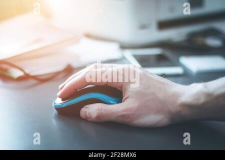 Computer input concept: Computer mouse and male hand Stock Photo
