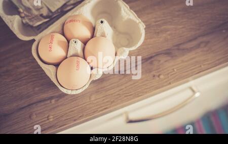 Fresh eggs in the morning: Cardbox of free range eggs in the kitchen Stock Photo