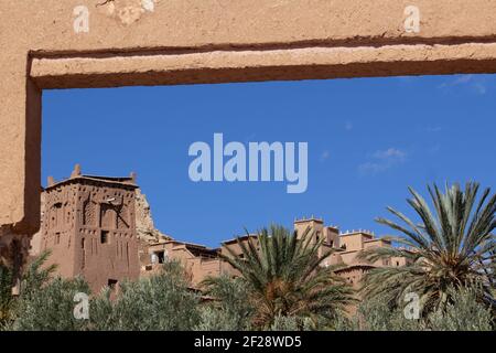 OUARZAZATE, MOROCCO - NOVEMBER 22; 2018  seen through the gate with date palms the Ksar of Ait-Ben-Haddou in the High Atlas Mountains of the Sahara Stock Photo