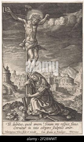 Christus aan het kruis.Christ hangs on the cross. Maria Magdalena embraces the foot of the cross. In the margin a two-legged caption in Latin. Stock Photo