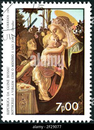 GUINEA-BISSAU - CIRCA 1985: A stamp printed in Guinea-Bissau, shown the painting by Botticelli (detail) - Virgin with Child and St. John, circa 1985 Stock Photo