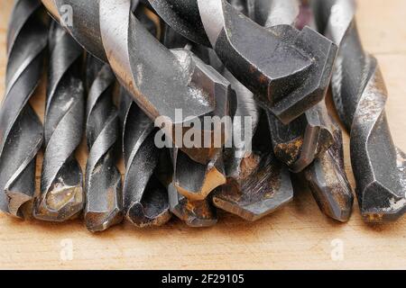 macro of various used drill bits, closeup of drilling tools Stock Photo