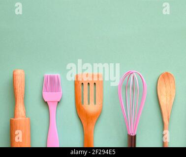 Cooking background. Flat kitchen accessories. Apron and silicone cooking  utensil with wooden handle on beige background with copy space. Top view  Flat Stock Photo - Alamy