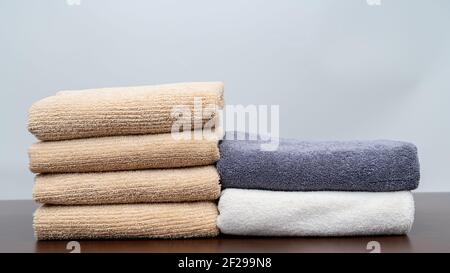 dry towels piled up on the wooden floor Stock Photo