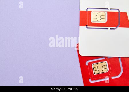 Sim cards for mobile phones on purple background Stock Photo