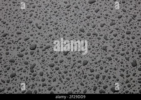 water drop on black metallic surface Stock Photo
