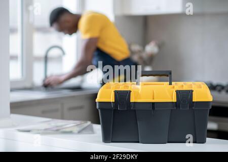 Dark-skinned service man working in the kitchen and looking concentrated on work Stock Photo