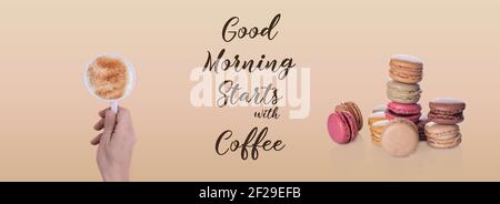 banner of hand holding a cup of coffee, macaroons and inscription Good morning starts with coffee on beige background Stock Photo