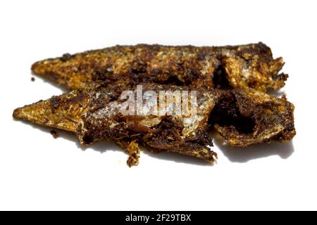 Indian mackerel fried with various spices and pepper in Kerala cuisine style, traditionally known as Ayala Varuthathu, isolated on a white background. Stock Photo