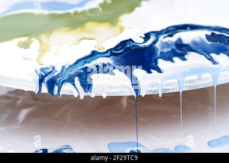 The process of creating a painting using fluid art technique. Stock Photo