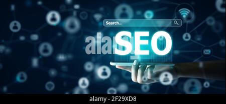 Search Engine Optimisation(SEO) on Smart phone Concept. Smart Phone of Businessman holding SEO Hologram. 3D Rendering and Copy space. Stock Photo