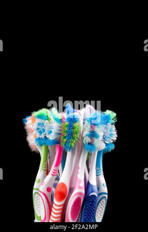 Used toothbrush isolated on black background. Plastic health care concept Stock Photo