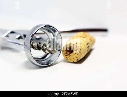 steel wing corkscrew with a perforated cork isolated on a white background. Stock Photo
