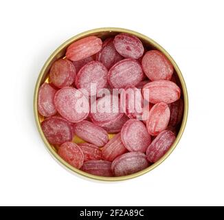fruit oval lollipops in an open round tin can on a white background, top view Stock Photo