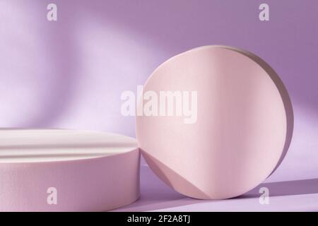 Cosmetic product presentation with shadows and light from windows. Lilac backdrop with pink round podium, display, mockup. Window natural shadow Stock Photo