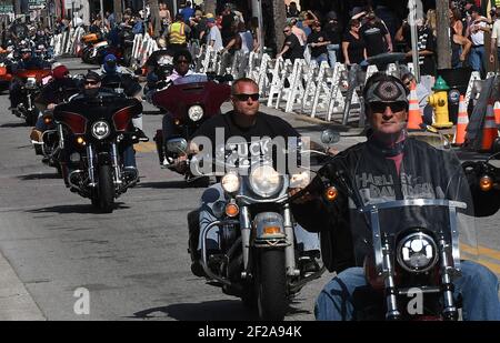 Daytona Beach, United States. 10th Mar, 2021. Motorcyclists ride down Main Street during the 80th year of Daytona Beach's annual Bike Week event. Few people were seen wearing face masks or practicing social distancing and some worry the gathering could become a superspreader event as the coronavirus pandemic continues. Credit: SOPA Images Limited/Alamy Live News Stock Photo