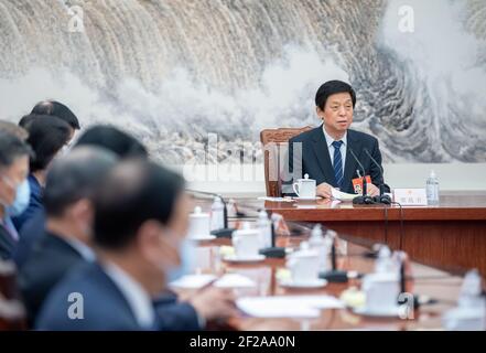 (210311) -- BEIJING, March 11, 2021 (Xinhua) -- Li Zhanshu, an executive chairman of the presidium of the fourth session of the 13th National People's Congress (NPC) and chairman of the NPC Standing Committee, presides over the third meeting of executive chairpersons of the presidium at the Great Hall of the People in Beijing, capital of China, March 11, 2021. (Xinhua/Zhai Jianlan) Stock Photo