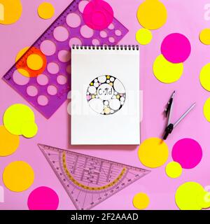 International Pi Day Happy Holiday Concept. Multicolored paper circles, school supplies and sketchbook with doodle zenart circle and circumference for Stock Photo