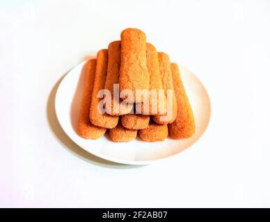 Sweet soft healthy soft spongy sprinkled sugar vanilla cookies (vainillas). Classic Argentine biscuits. White background. High angle shot. Stock Photo