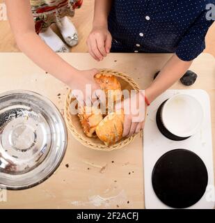 Children play in kitchen. Boy and girl with bread rolls in toy kitchen above view Stock Photo