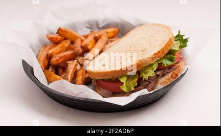 home made roast beef sandwich on sourdough bread with crispy french fries Stock Photo