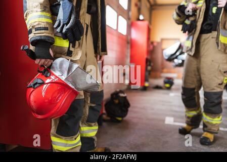 Red helmet in fireman's hand Stock Photo